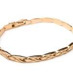 Gold bracelet on white background